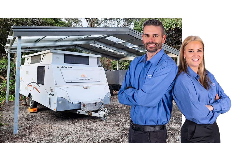 Caravan under a a carport with sales staff